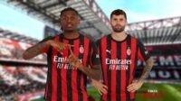 Dua pemain AC Milan di lapangan stadion dengan seragam merah hitam.